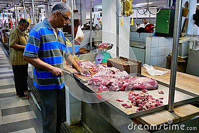 A butcher at work in a market in Georgetown, Penang Editorial Stock Photo