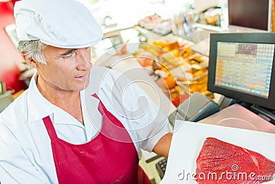 Butcher at work in shop Stock Photo