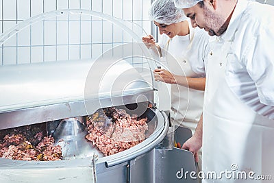 Butchers in butchery processing meat Stock Photo