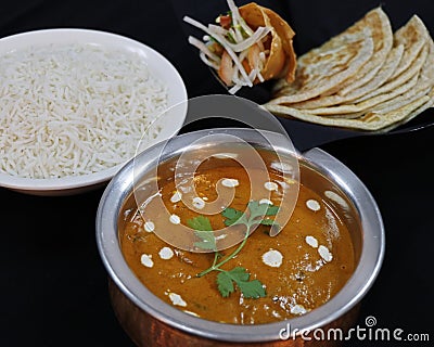 butter chicken curry with basmati rice and indian bread with black background Stock Photo