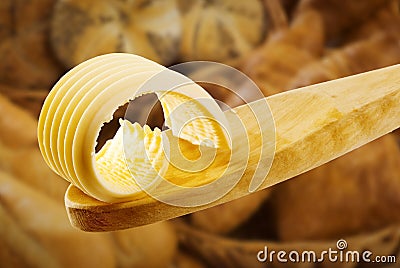 Butter curl on a wooden spoon Stock Photo