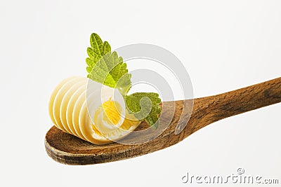 Butter curl on a wooden spoon Stock Photo