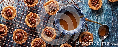 Butter Pecan tartlets on a copper wire cooling rack ready for eating. Stock Photo