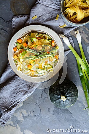 Butter squash pasta salad with zucchini slices, cheddar cheese and scallion Stock Photo