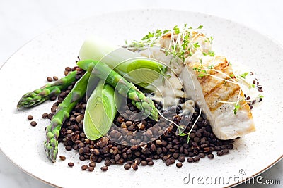 butterfish with green lentils, leek and green asparagus Stock Photo