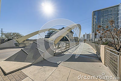 Butterfly bridge in Austin Texas against buildings and sun in the blue sky Stock Photo