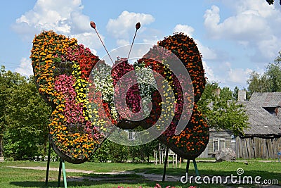 Butterfly symbol decoration made of many flowers in street Stock Photo