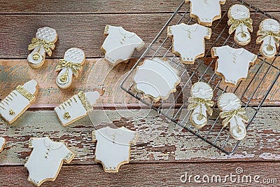 Buttery biscuits covered with royal icing. in the form of a baby bodysuit, a bottle and a rattle top view Stock Photo