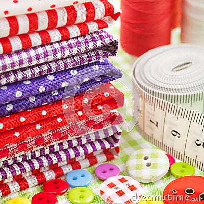 Buttons, colorful fabrics, measuring tape, pin cushion, thimble Stock Photo