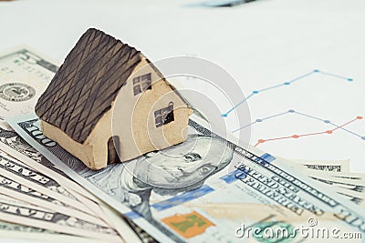 Buy and sell house or real estate, home loan, mortgage and property investment concept, miniature house on pile of US dollar bank Stock Photo