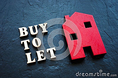 Buy to let and red home on the stone. Stock Photo