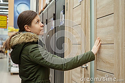 Buyer chooses door in store. Shop window of doors. A large selection of doors for house Stock Photo