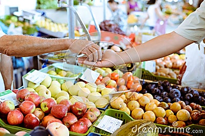 Buyer's hand and seller's hand in colorful Stock Photo