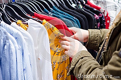 Buyer woman chooses clothes in store Stock Photo