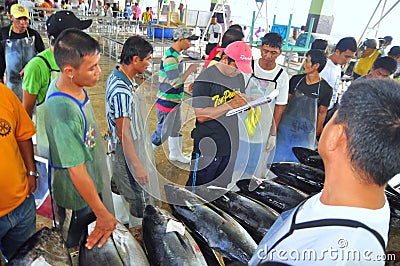 Buyers are checking the quality of tuna at the seaport Editorial Stock Photo