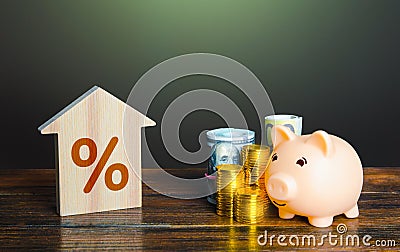 Buying a house with savings. Piggy bank and buying a home with a mortgage. Invest in real estate. Favorable conditions, low Stock Photo