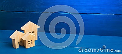 Buying and selling of real estate, construction. Three houses on a blue background. Apartments and apartments. City, settlement Stock Photo