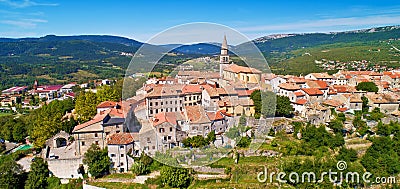 Buzet. Hill town of Buzet surrounded by stone walls in green landscape aerial panoramic view Stock Photo