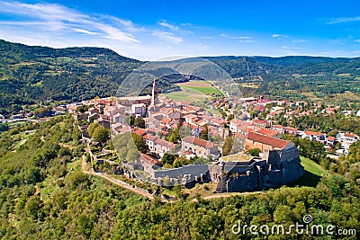 Buzet. Hill town of Buzet surrounded by stone walls in green landscape aerial view Stock Photo