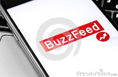 BuzzFeed logo on the screen smartphone. BuzzFeed is an online media news company Editorial Stock Photo