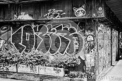 BW of graffiti walls by unknown artist at Chalermla Public Park on Phayathai Road Editorial Stock Photo
