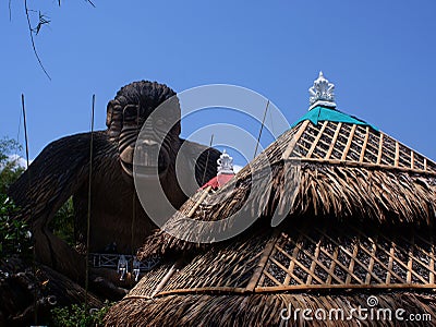 Cabana roof obscures the view of giant gorilla clay statue. Editorial Stock Photo