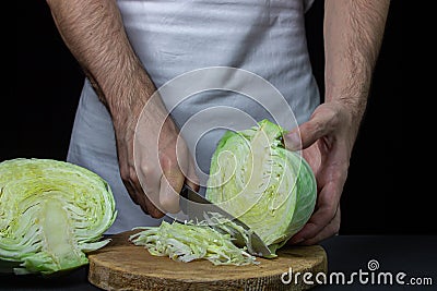 Cabbage on a dark background. Shred cabbage chef on black background. Stock Photo