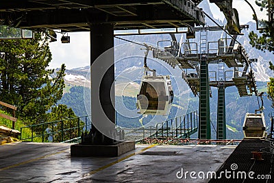 Cabin of Cable car lift arrive to top of the mountain with place of rest, restaurant and hotel in summer sunny day Stock Photo