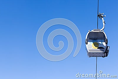 Cabin cableway on a background of blue sky Stock Photo