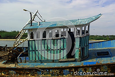 The cabin of dilapidated fisherman boat on a indian small harbor. Stock Photo