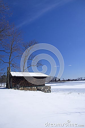 Cabin on frozen lake Stock Photo