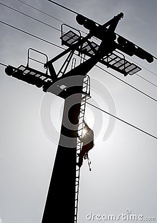 Cabin lift pillar silhouette and rescuer Stock Photo