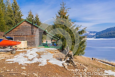 Cabin near a Frozen Lake on a mountain Stock Photo