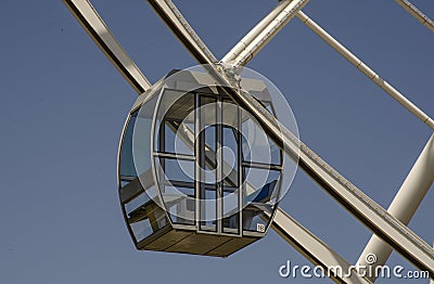 Cabin and support of a ferris wheel on a background of clear blue sky Stock Photo