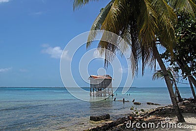 Cabins on stilts on the small island of Tobacco Caye, Belize Stock Photo