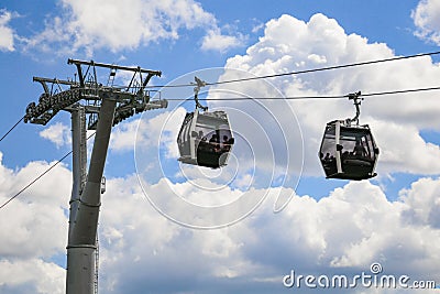 A cablaway with two cable car on a partly cloudy blue sky Stock Photo