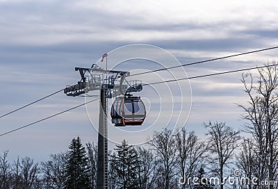 Cable car cabin over the weathered trees Stock Photo