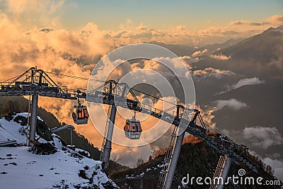 Cable car ski lifts in Gorky Gorod mountain ski resort can. Beautiful scenic sunset landscape. Sochi, Russia, Caucasus Stock Photo