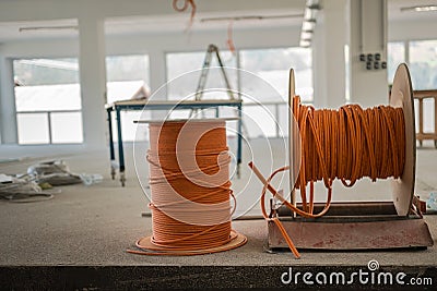 Cable drums with orange fiber cable on a construction site Stock Photo