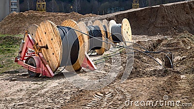 Cable high voltage electric in roll or round coil on ground. Concept of electricity supply for construction projects Stock Photo