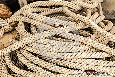 Cable long dark beige natural jute closeup marine background Stock Photo