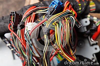 A cable of matted wires of different colors with connectors in the electrical wiring of the car. Internet line in the work of the Stock Photo