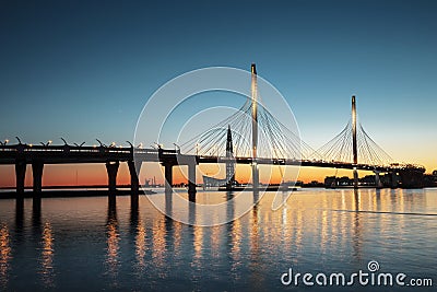 The cable-stayed bridge over Petrovsky fairway and the tower of Lakhta center, at sunset, Saint-Petersburg, Editorial Stock Photo