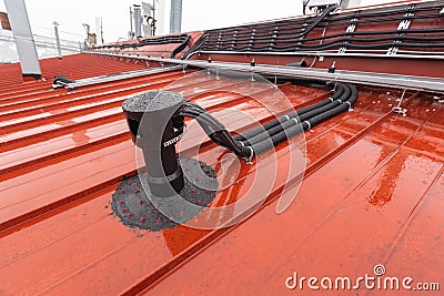 Cable tray outside with telecommunications cables, optic fiber, power cables and transmitter data cables from antennas Stock Photo