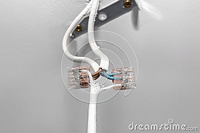 Cables from the LED lighting connected to the power supply in the ceiling with a quick connector for three wires for cables. Stock Photo