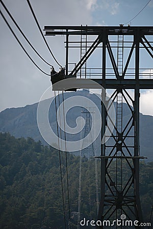 Cableway on the background of Tahtali mountain on a cloudy day. Taurus Mountains Stock Photo