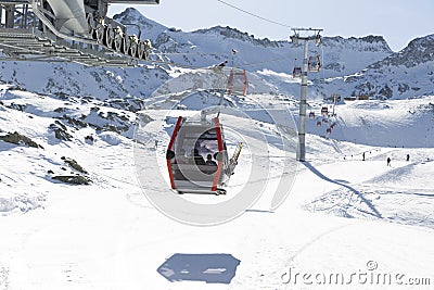 Cableway lift cable cars, gondola cabins on winter snowy mountains background beautiful scenery. Stock Photo