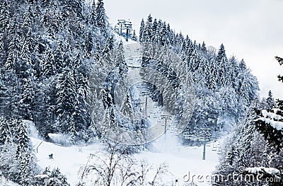 Cableway ski lift on ski slopes in winter scenery in Julian Alps, Kranjska Gora, Slovenia Stock Photo
