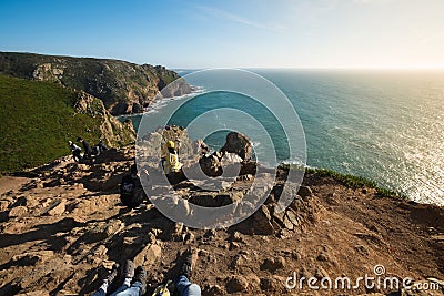 Tourists relax and take pictures on the background of beautiful view of the ocean and cliffs Editorial Stock Photo