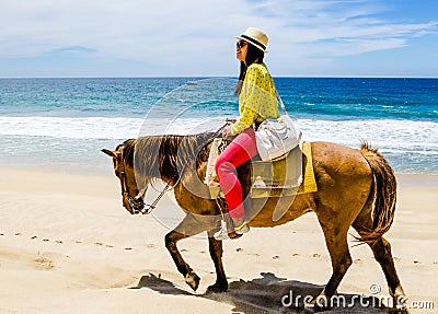 Young girl horseback riding on the beach in Cabo san Lucas, Baja California Editorial Stock Photo